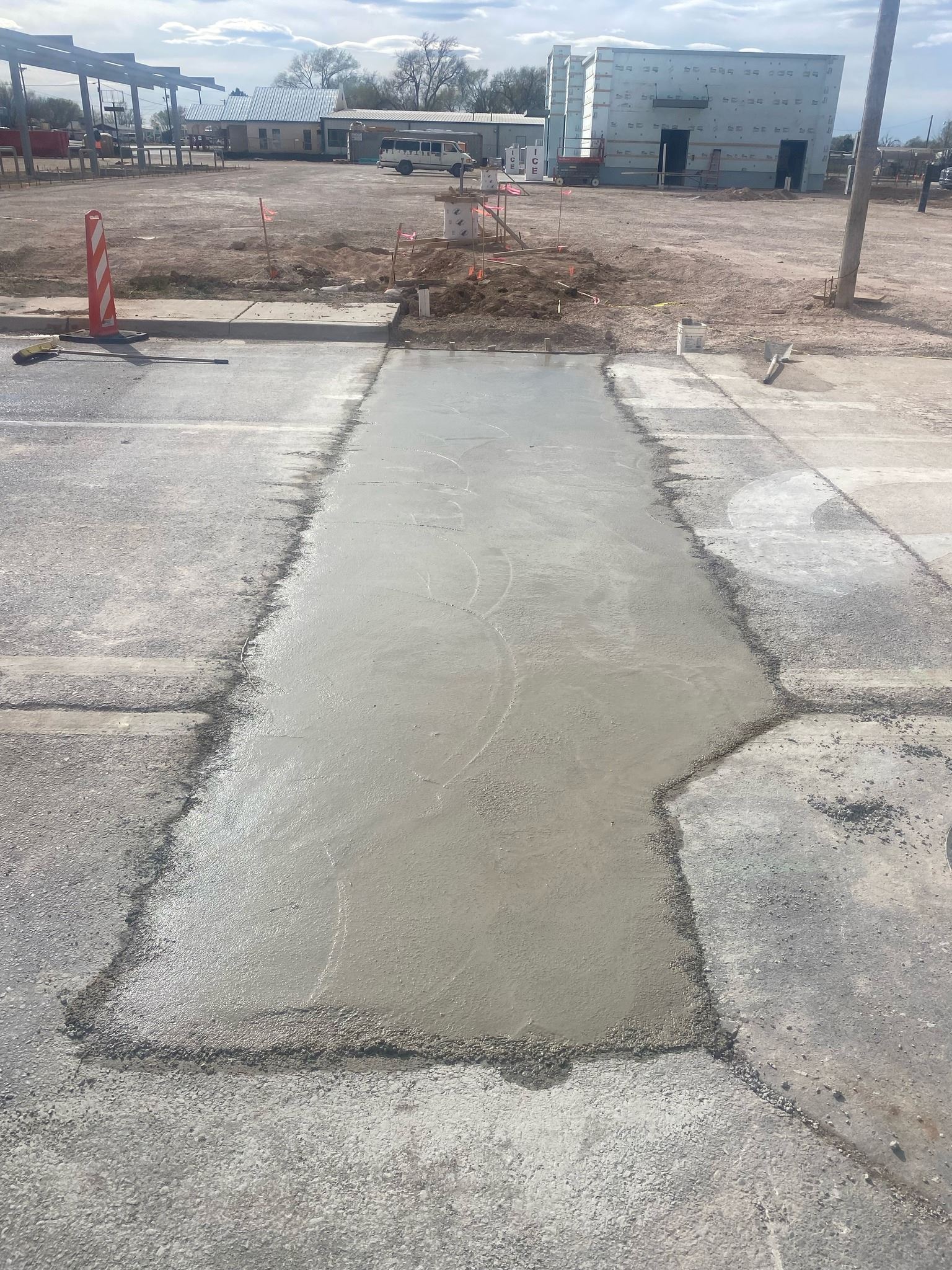 26th Street Update photo showing patch in parking lot or roadway